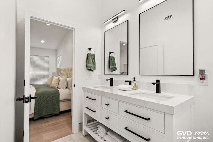 Contemporary bathroom with dual vanities, black fixtures, and modern wall mirrors in Antelope, CA home