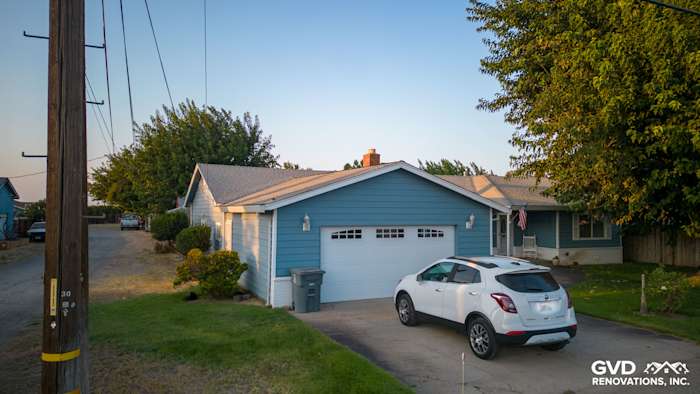 Home exterior showcasing newly installed blue Alside Prodigy vinyl siding and a driveway in Yuba City, CA