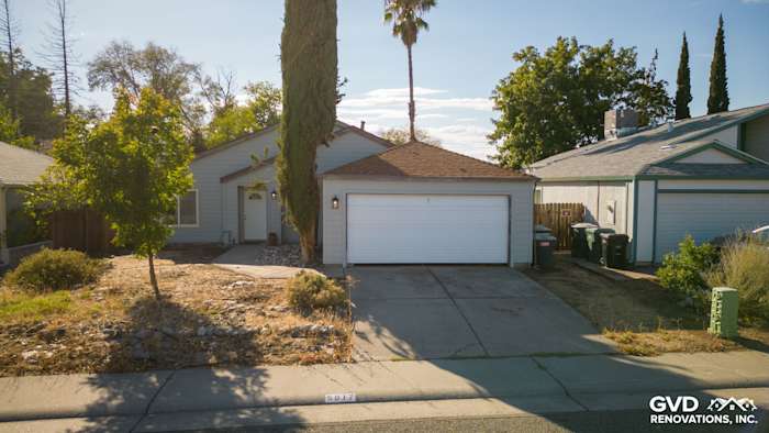 Single-story home exterior with James Hardie siding, updated landscaping, and a two-car garage in Sacramento