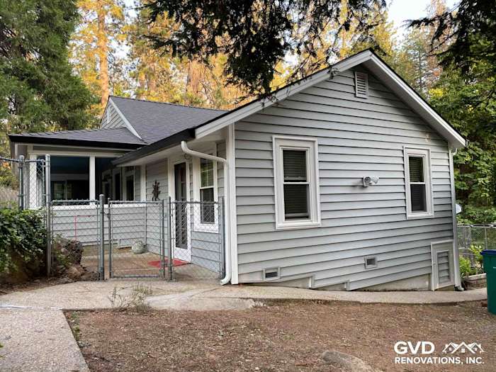 Updated home exterior featuring Prodigy Vinyl Siding in light gray, surrounded by landscaped yard in Grass Valley, CA