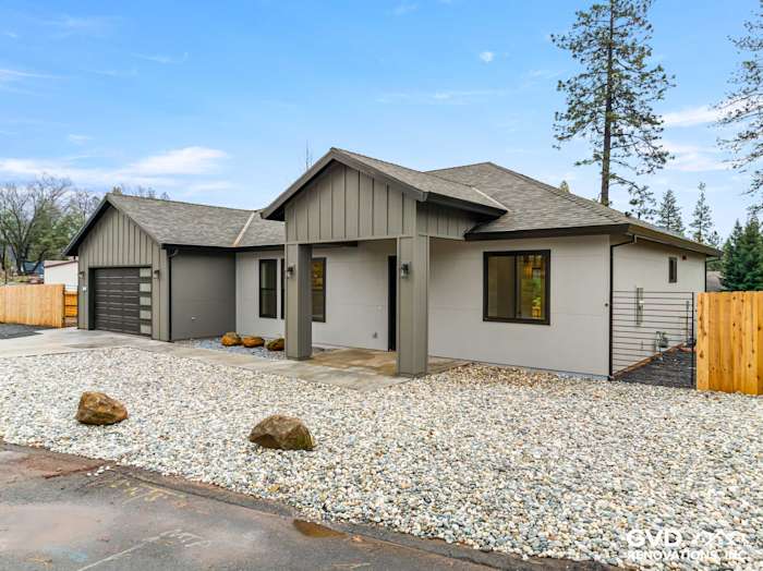 New construction home exterior in Paradise, CA featuring James Hardie Architectural Panels in Sea Grass and Milgard black
