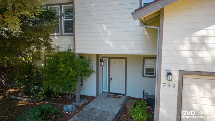 Elevated view of a home exterior featuring James Hardie siding in soft beige, with modern trim and pathway
