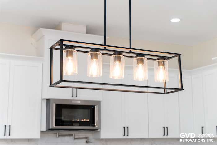 Modern kitchen pendant light fixture over quartz countertop in a custom home build in Paradise, CA
