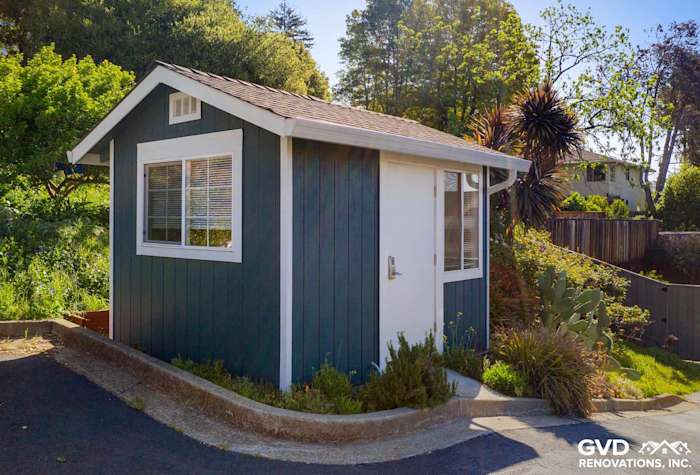 Stylish garden shed with James Hardie lap siding in deep blue and white trim, Oakland, CA