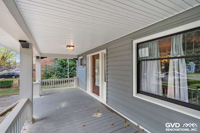 Gray vinyl siding exterior renovation featuring a covered porch and large windows in Dixon, CA
