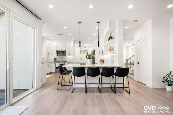 Modern kitchen remodel in Antelope, featuring quartz countertops, custom cabinets, and stylish bar seating