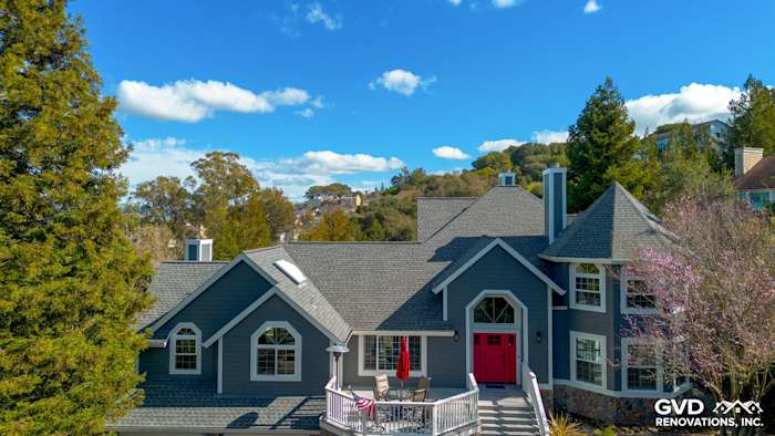 Petaluma home exterior featuring Night Gray James Hardie siding and Arctic White trim, with red front door and landscaped