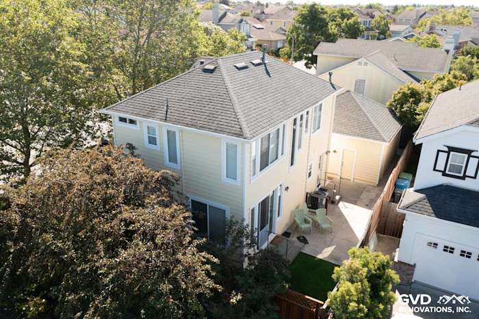 Two-story home in Petaluma featuring Prodigy Insulated Vinyl Siding in light yellow, surrounded by greenery