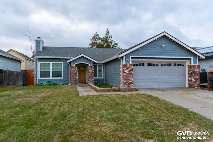 Home exterior featuring James Hardie Siding in Boothbay Blue with Arctic White trim and brick accents in Sacramento