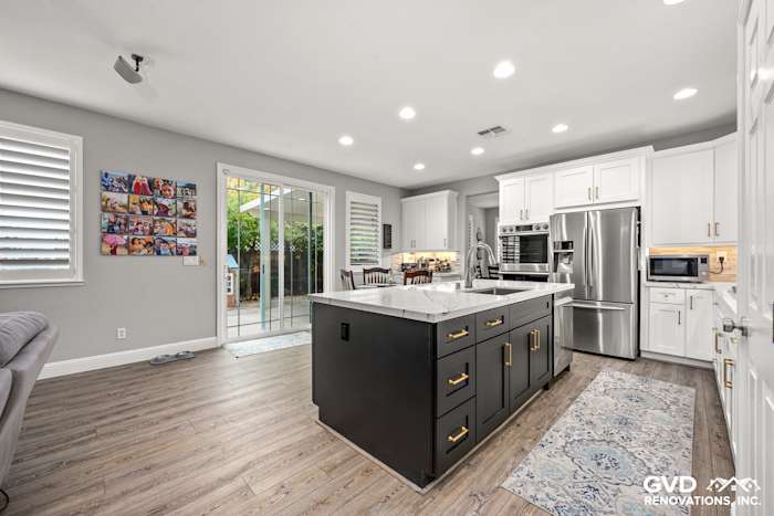 Modern kitchen remodel in Roseville, featuring Cambria countertops, custom cabinets, and warm wood flooring