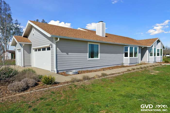 Pearl Gray James Hardie siding and Arctic White trim on a Galt home with Anlin windows and landscaped yard