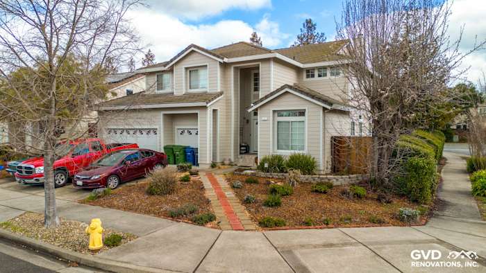 Two-story home in Petaluma with James Hardie Cobble Stone siding, Arctic White trim, and landscaped front garden