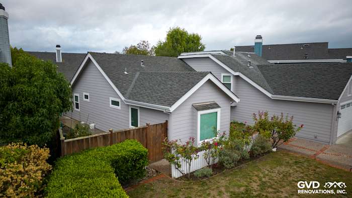 Home exterior featuring Pearl Gray James Hardie siding and Milgard windows, surrounded by landscaping in Foster City