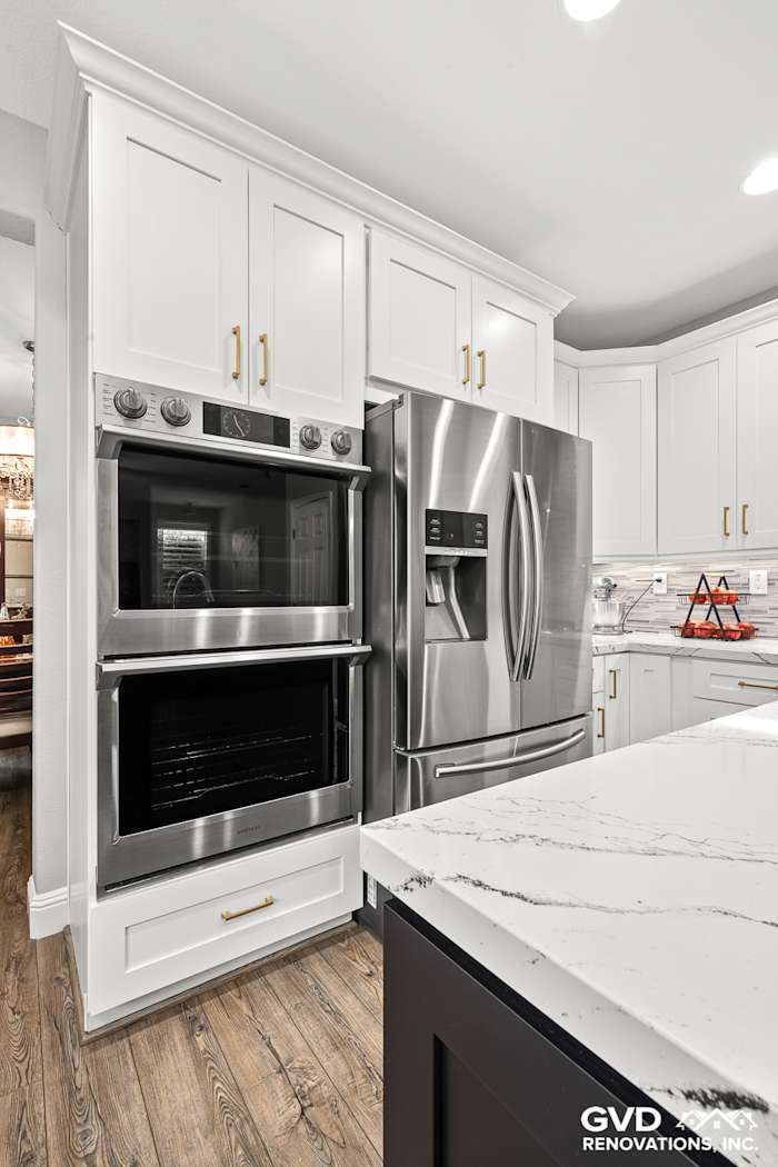 Modern kitchen featuring Cambria quartz countertops, stainless steel appliances, and white custom cabinets in Roseville