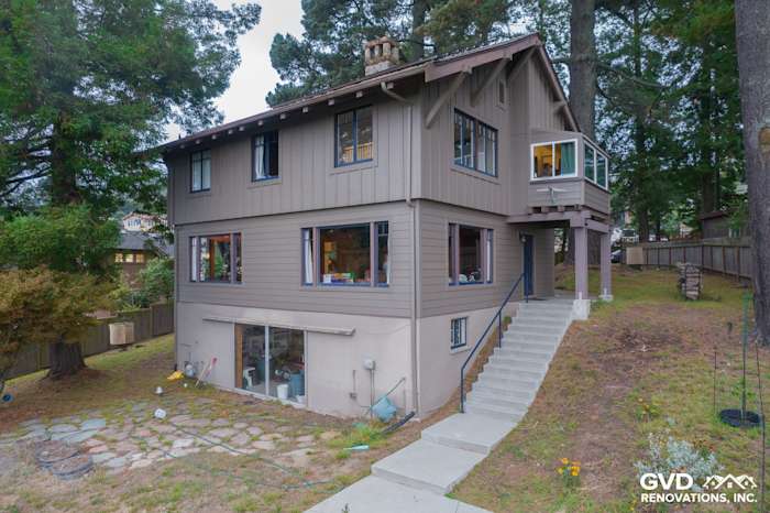 Newly remodeled home in Berkeley featuring Timber Bark James Hardie siding and Anlin windows, with landscaped yard and deck