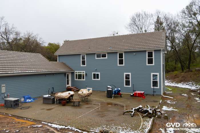 Sutter Creek home featuring Boothbay Blue James Hardie siding and Milgard windows, with a spacious patio