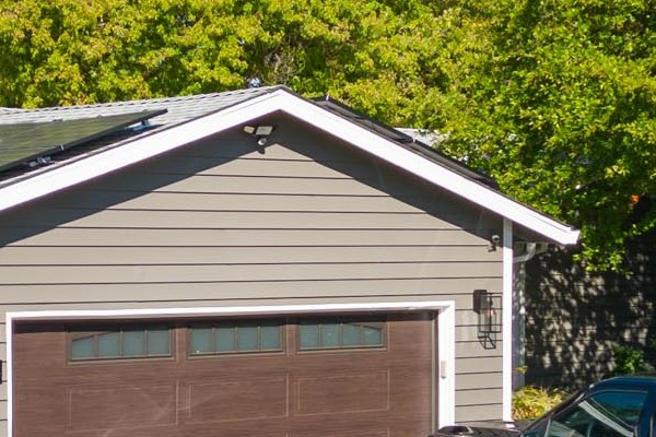 Home exterior in Carmichael featuring new Alside Prodigy vinyl siding and Milgard windows, with a truck parked nearby