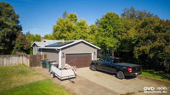 Home exterior in Carmichael featuring new Alside Prodigy vinyl siding and Milgard windows, with a truck parked nearby