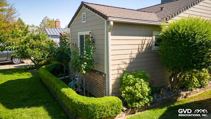 Khaki Brown James Hardie siding on a freshly remodeled home exterior with landscaped garden in Sacramento
