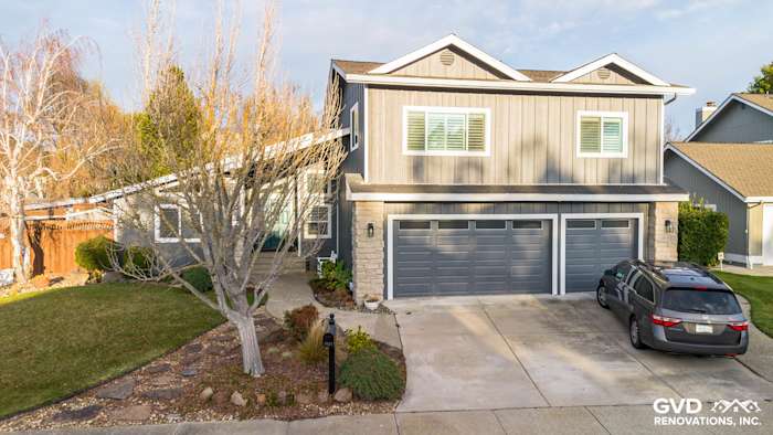 Home exterior in Dublin, CA featuring James Hardie Night Gray siding and Arctic White trim, with a landscaped yard