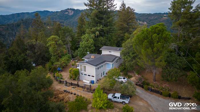Home exterior in Los Gatos featuring new James Hardie Cobble Stone siding and Arctic White trim surrounded by greenery