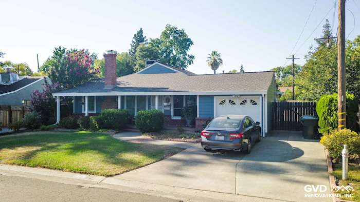 Sacramento home with Boothbay Blue James Hardie siding and Arctic White trim, featuring a landscaped front yard and driveway