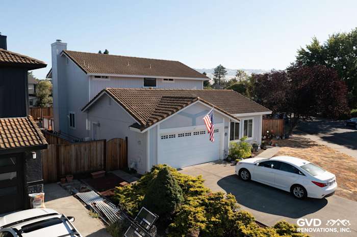 Modern home exterior in Petaluma, featuring new siding, windows, and a charming entryway with a flag