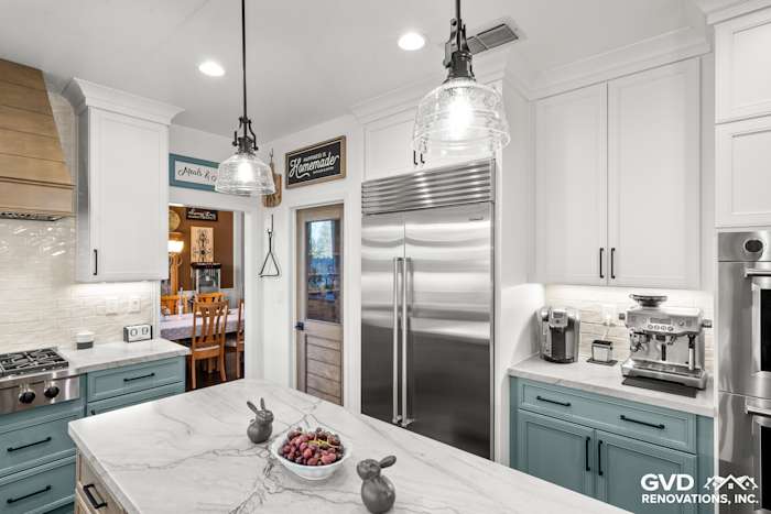 Modern kitchen with MSI Denali White Quartzite countertops, stainless steel appliances, and elegant Fieldstone cabinetry