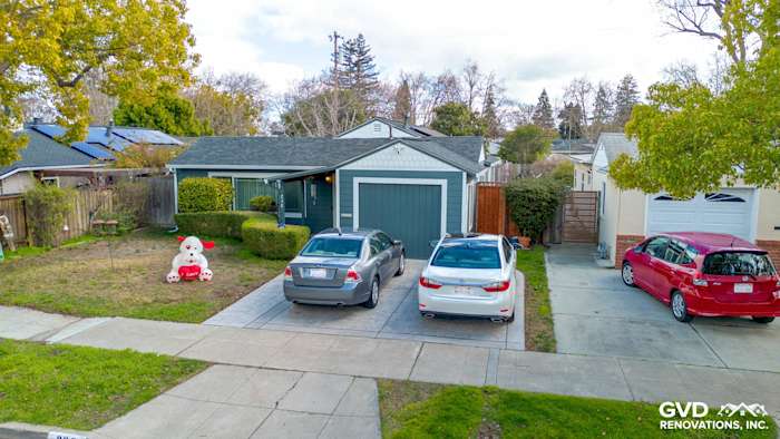 House exterior featuring James Hardie siding in Evening Blue with Arctic White trim and a landscaped front yard in Redwood
