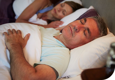 A couple in their 40s are sleeping soundly, as they know that they can rely on Fixodent to help make living with dentures fun. 