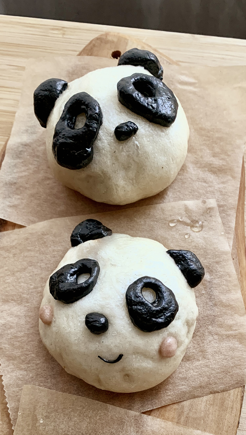 Panda steamed baos, made with dough that has been mixed with black squid ink or beet juice.