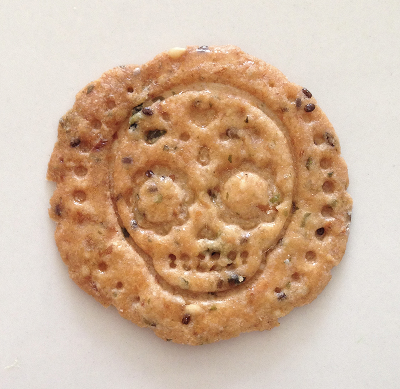 Savory cracker with a calaveras skull imprint.