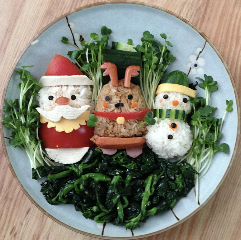 Santa, a reindeer, a snowman made of rice, sausage, red bell pepper, and cucumber.
