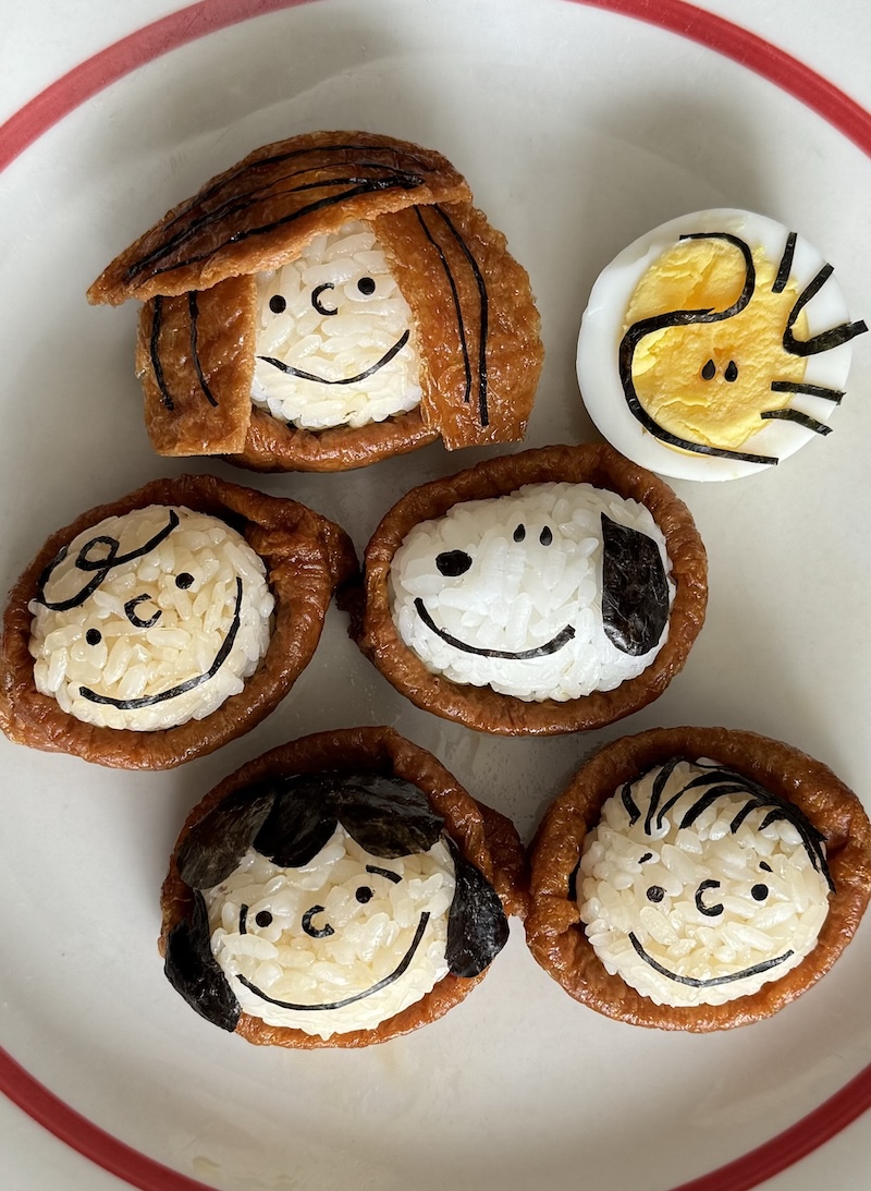 The Peanuts characters are made with rice, tofu wrappers, a hard-boiled egg, and nori.
