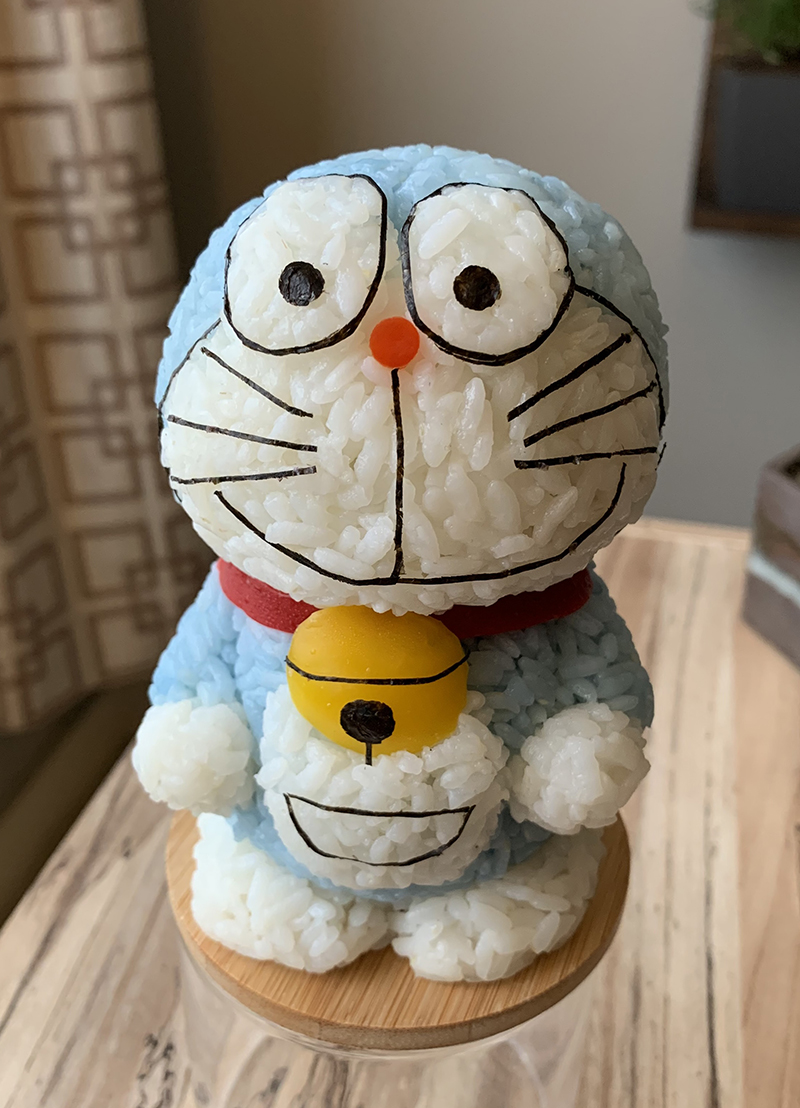 Doraemon, made of rice soaked in butterfly pea flowers, yellow and red bell peppers, and nori.