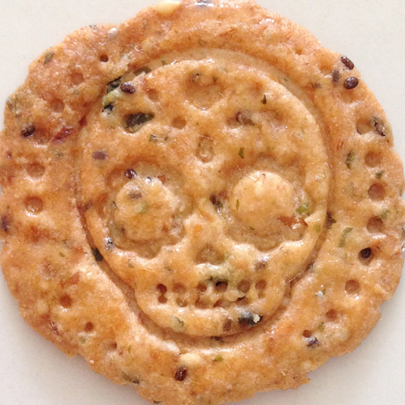 Cracker imprinted with sugar skull design