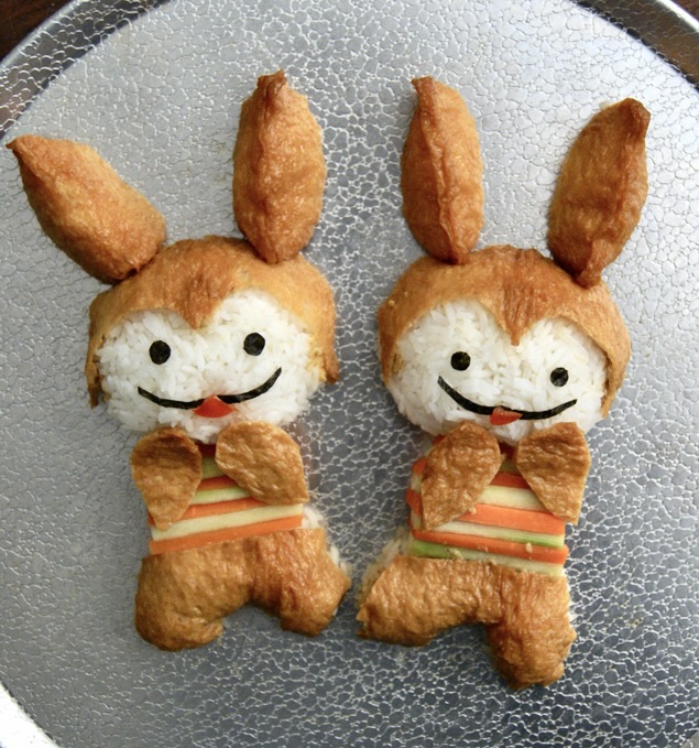 Inari Rabbits food art made of rice, tofu wrappers, nori, carrots, and cucumbers.