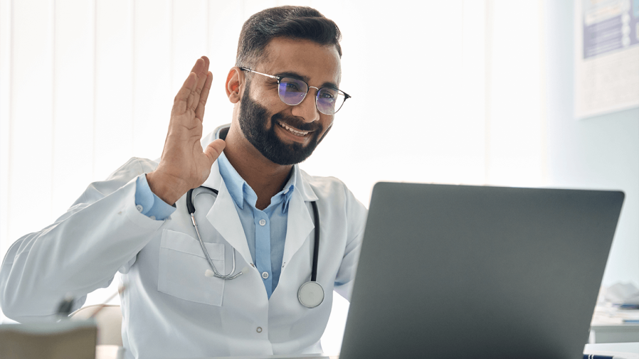 healthcare provider smiling and on a video call with patient