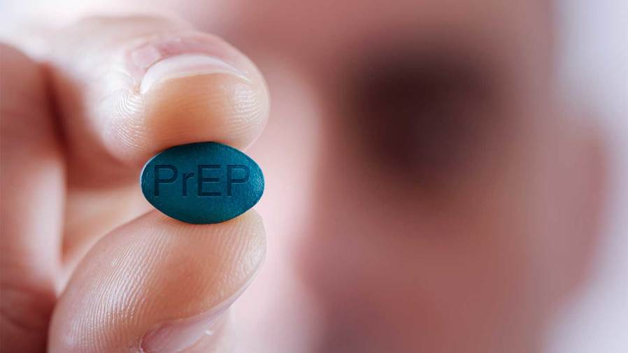 man hold blue pill with PrEP written on it