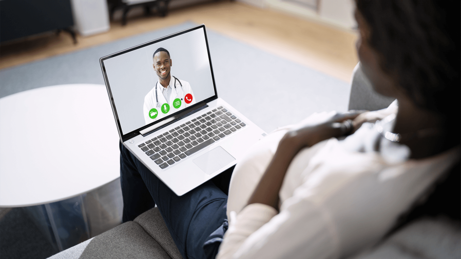 African American female pregnant on video call with African American male doctor