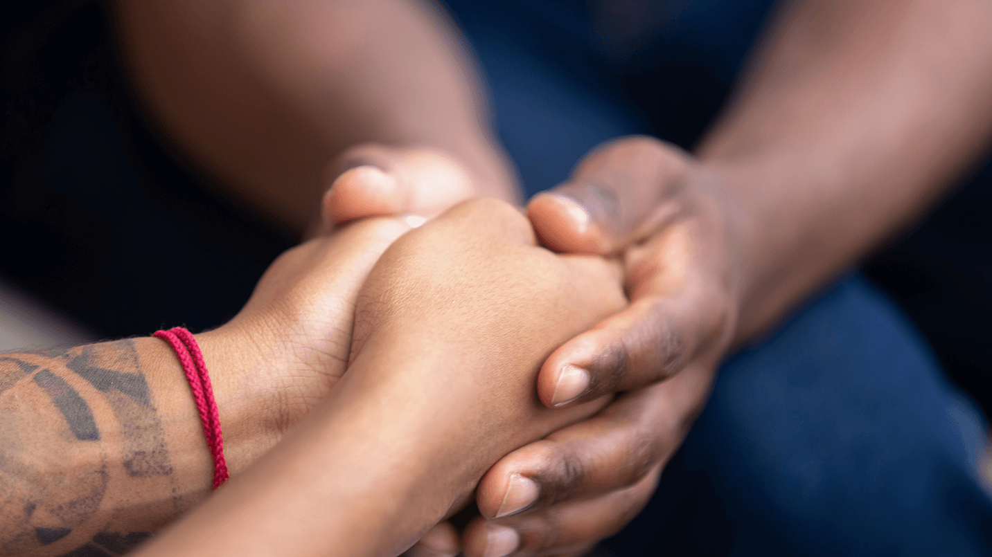 Close up of two people holding hands
