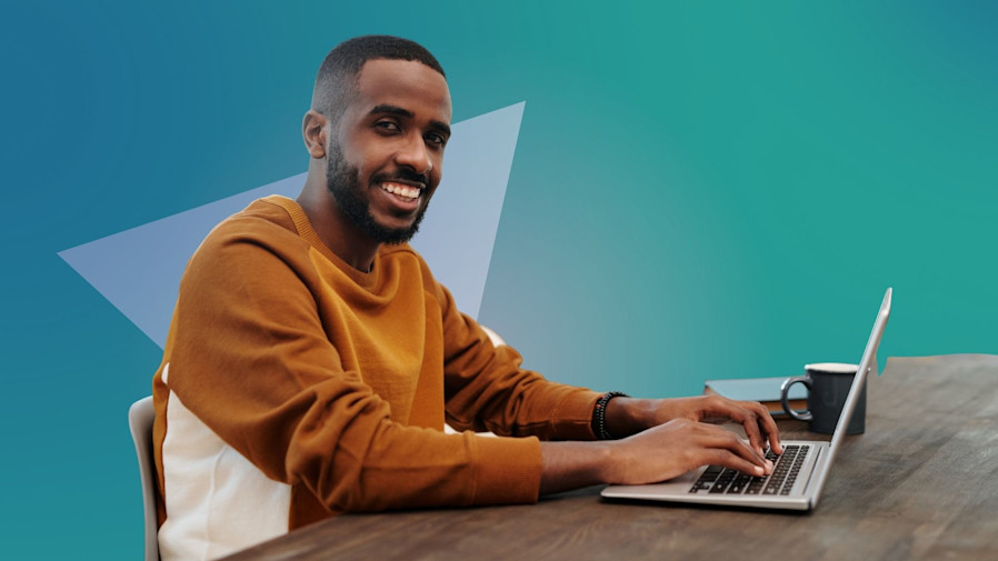 African American male sitting at a desk searching for a men's health company on his laptop