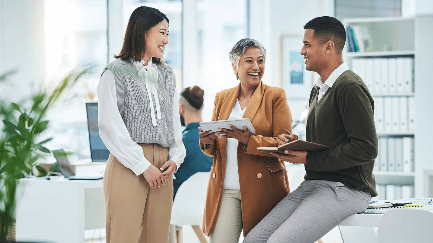 happy, healthy employees chatting in their office
