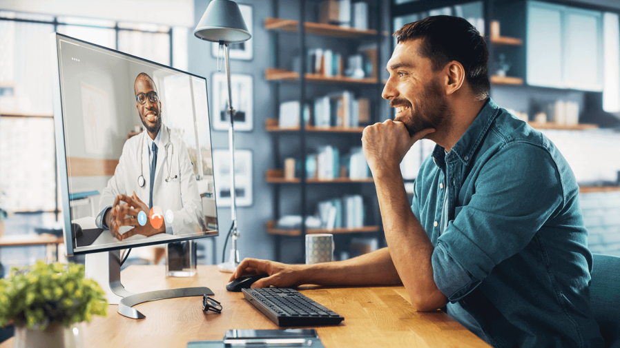 Man taking a telehealth appointment from a desk