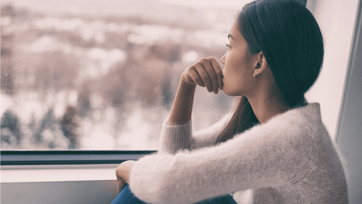 Female-sadly-looking-out-the-window