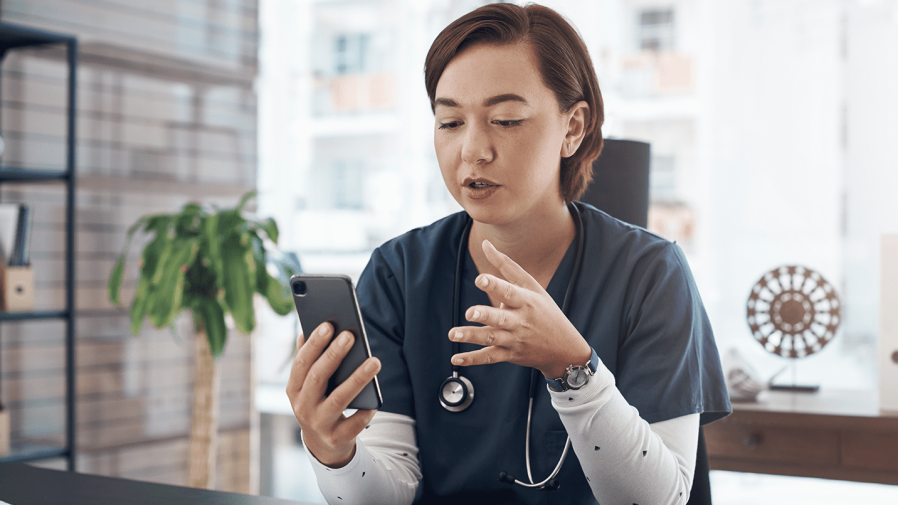 Healthcare-provider-communicating-with-patient-via-telehalth-on-cellular-device 