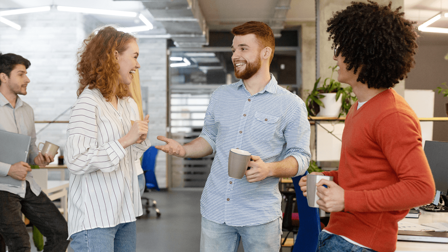 employees smiling and chatting at the office