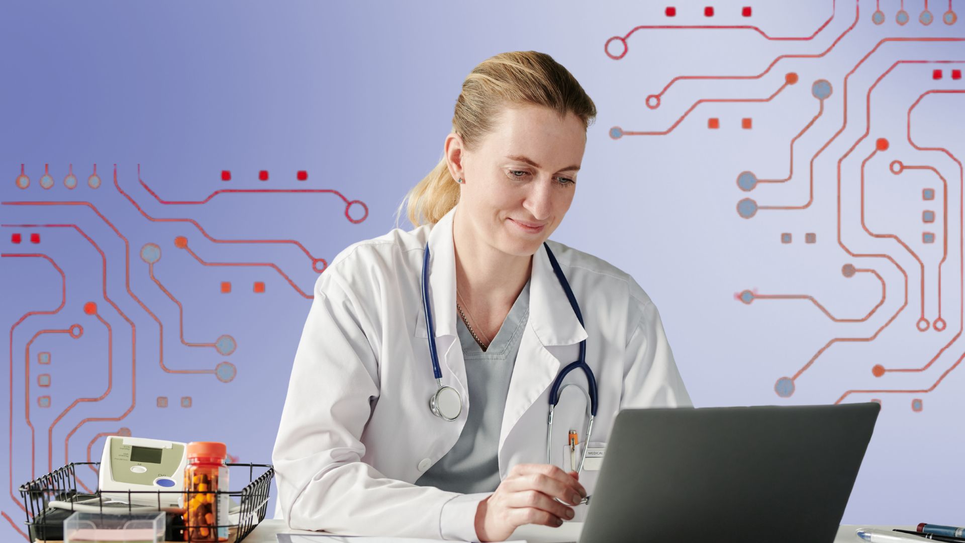 Smiling female doctor sitting in front of a computer and typing