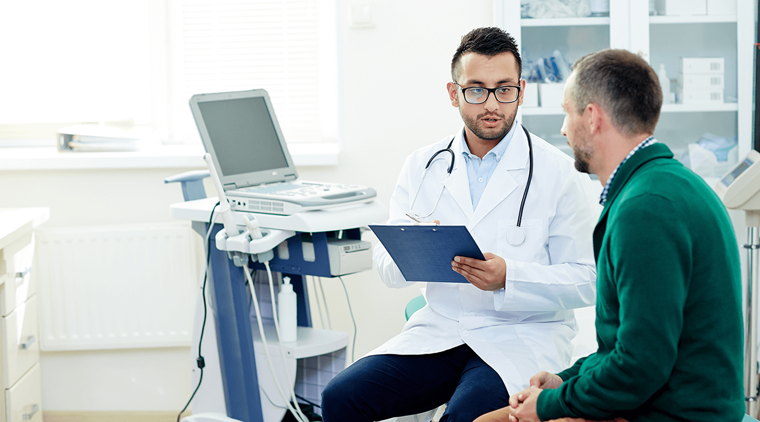 doctor-speaking-to-white-male-in-clinic