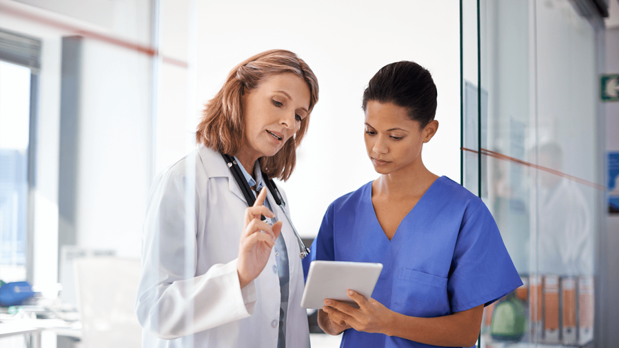 two female physicians discussing a patient's test results and medical history